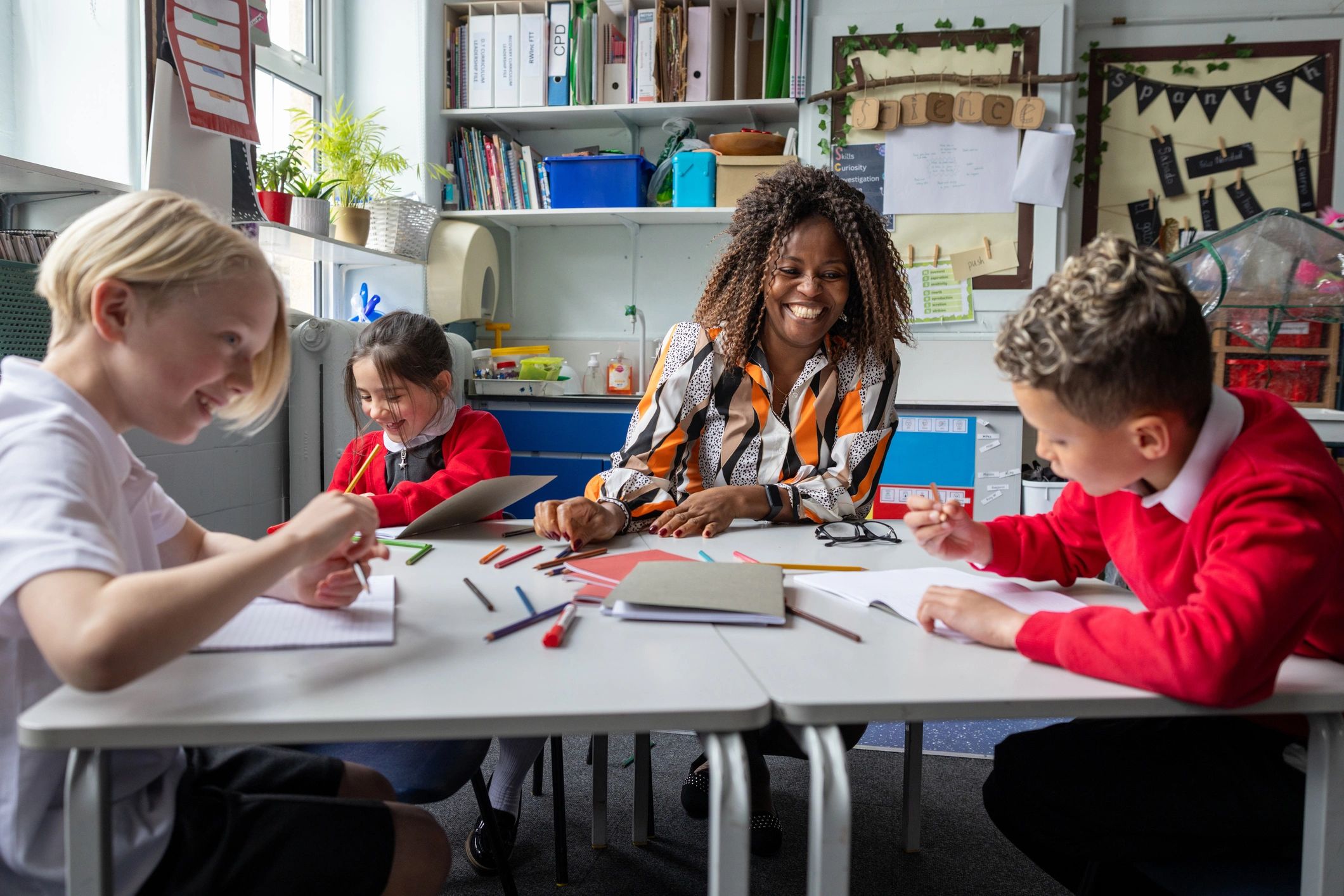 Teacher working with students using textbooks in class