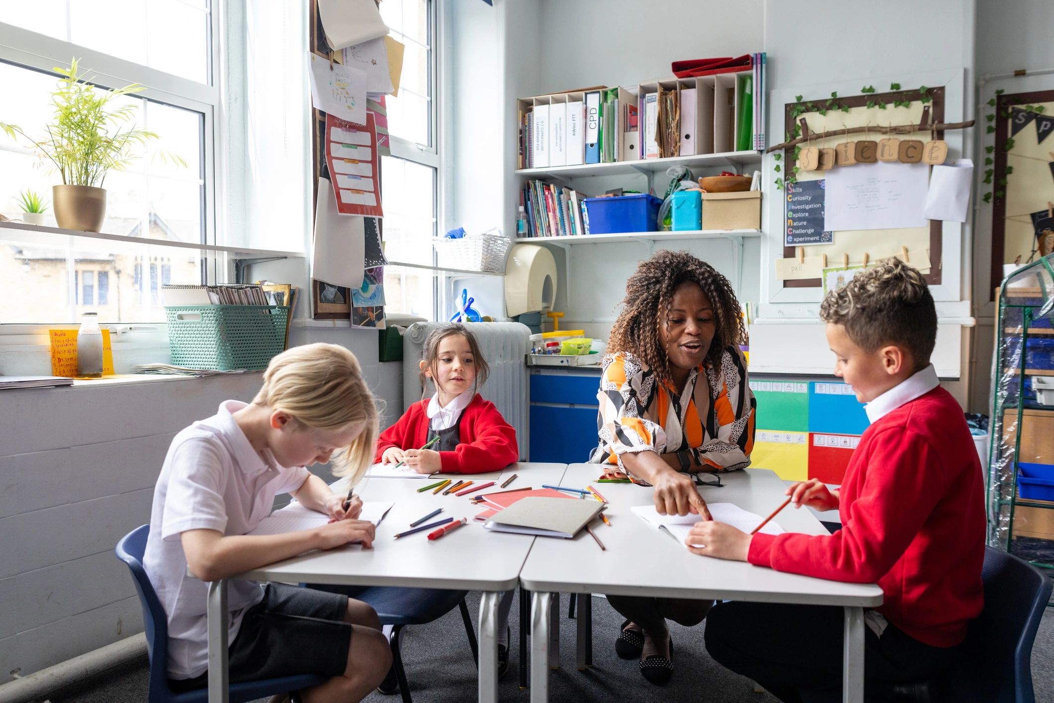 Teacher helping students with textbooks