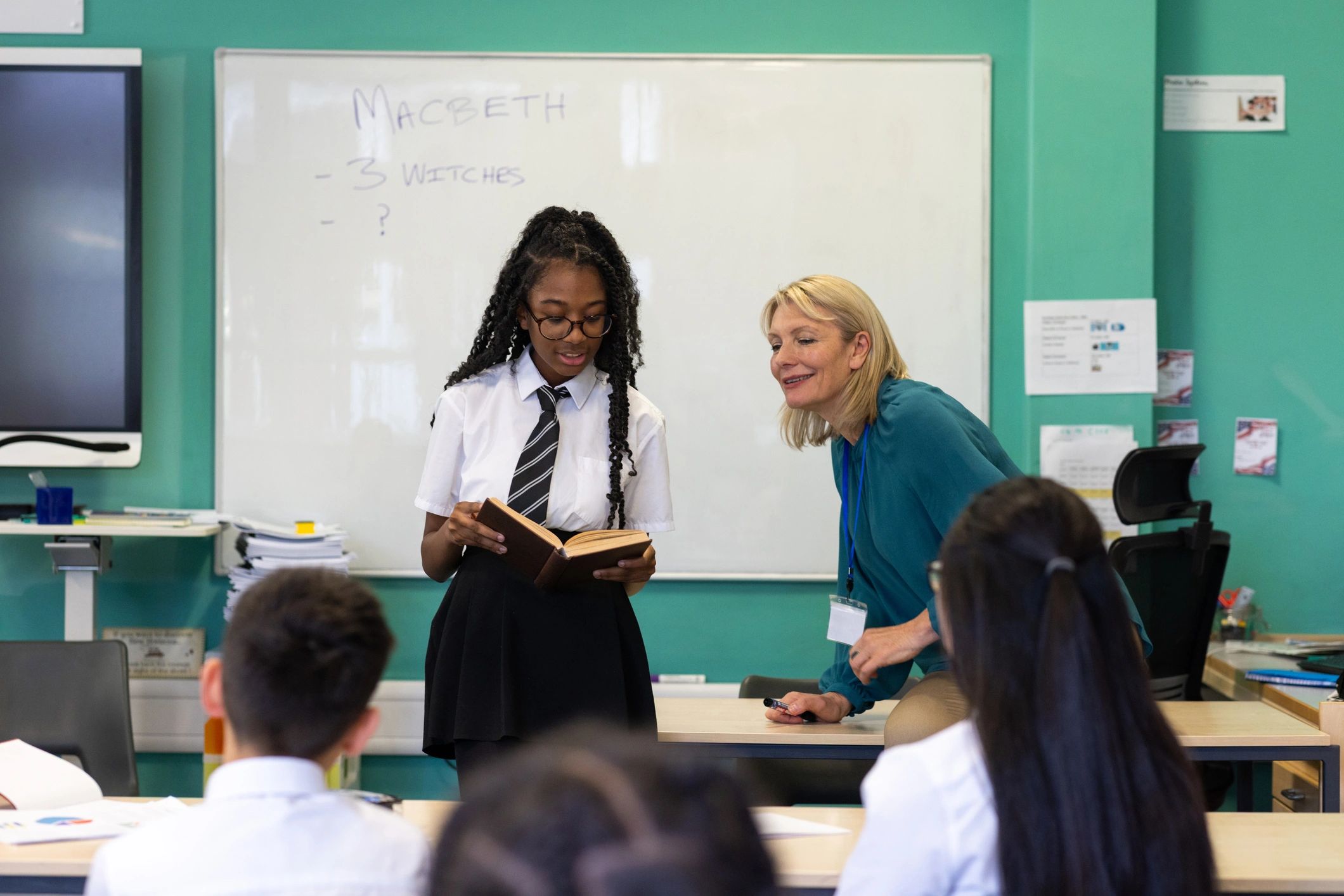 Student reading aloud with teacher support