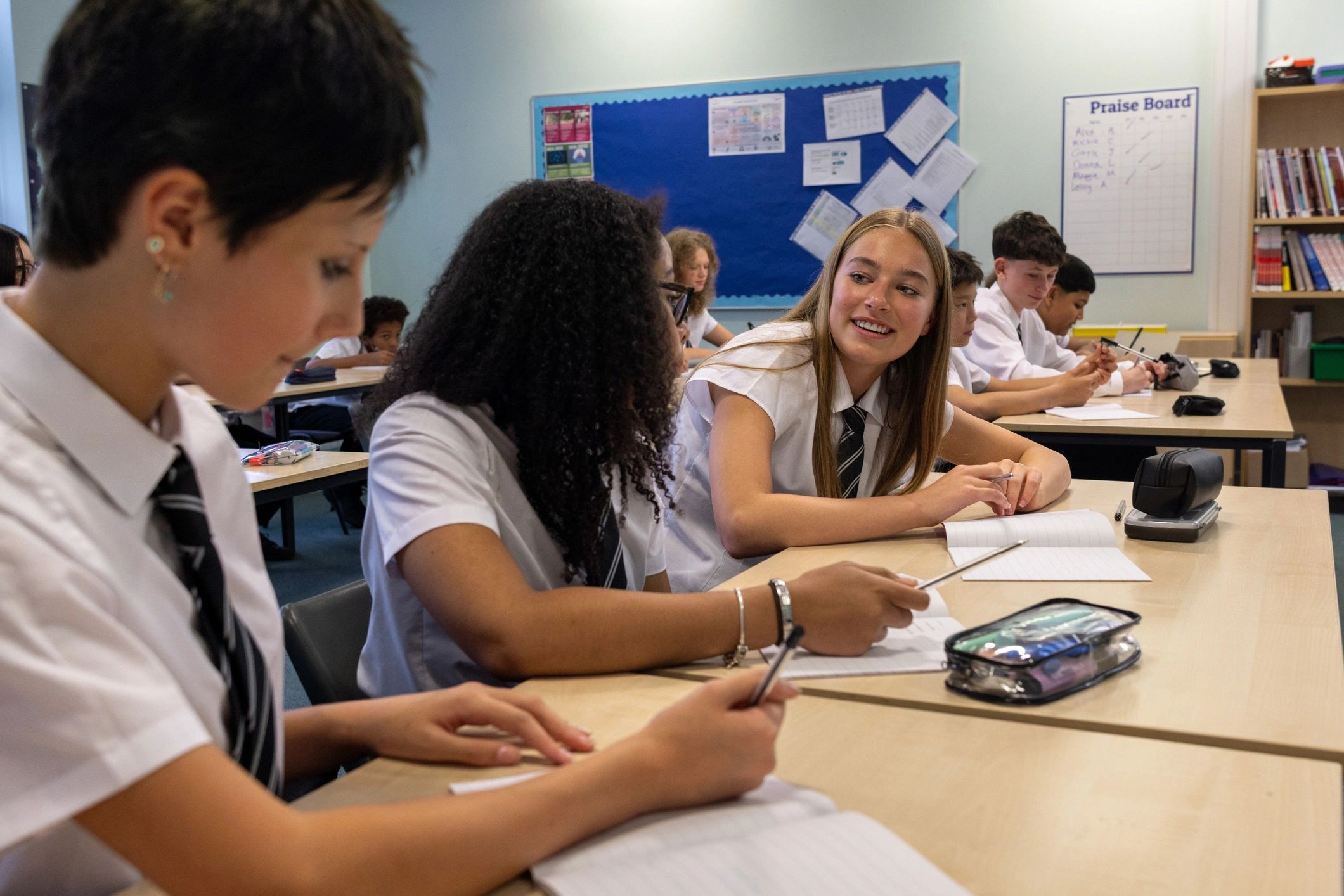 Students working in notebooks during class