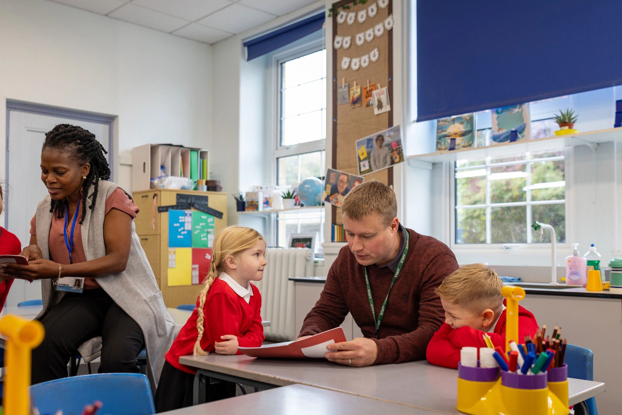 Teacher supporting students during classroom learning