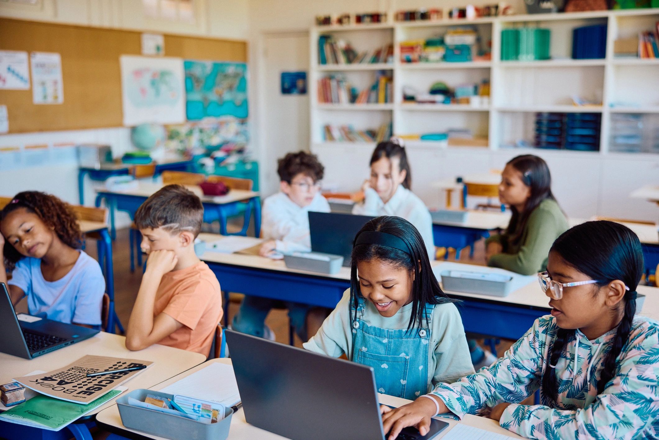 Students using technology together in a classroom